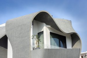 Sculptural Concrete Ribbon Façade Abstracts Emotion And Warmth