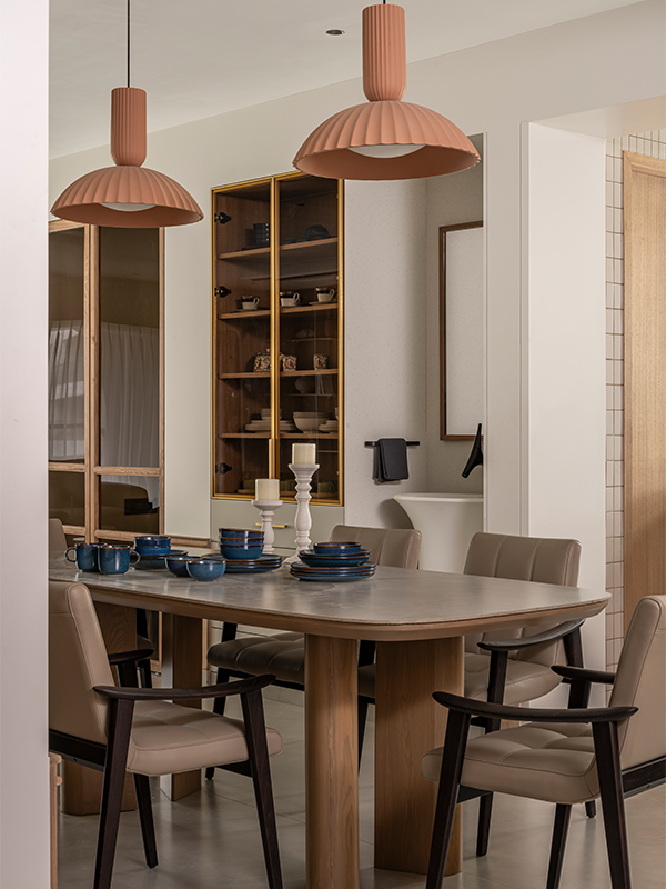 Earthy hues with a pop of terracotta lighting from Littoria brighten up the dining area. (Image Credit: Noaidwin Sttudio) 