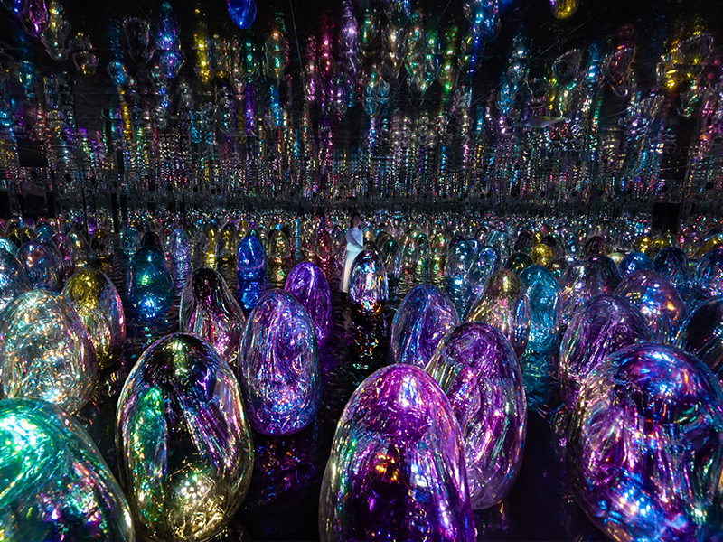 Floating Microcosms (2025, from the series teamLabBall, 2009–) transforms human interaction into cascading waves of light and sound, as responsive Ovoids blur the boundaries between body and sculpture. (Image Credits: Courtesy of teamLab and Pace Gallery)