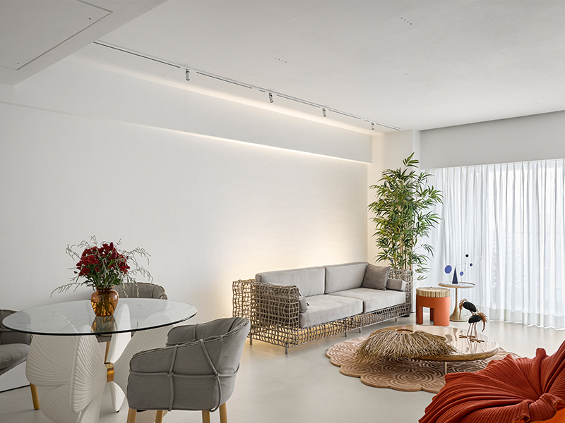 The Gingko dining table with Parchment armchairs from Kenneth Cobonpue leads one to the living room and is punctuated with a pop of verdure. (Image Credits: Isha Shah)