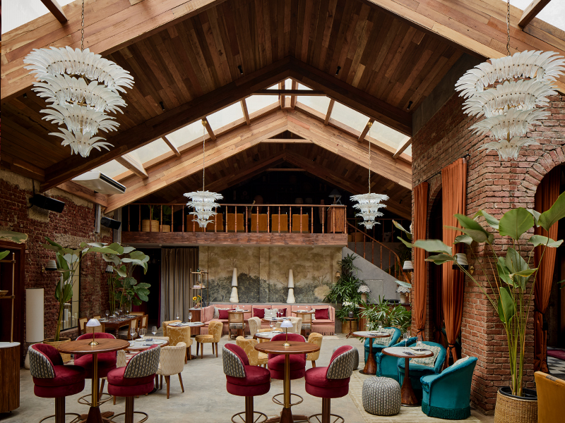 Beyond, soaring slanted roofs clad in warm wood panelling and an expansive glass skylight evoke the charm of alpine retreats, blending scale with serenity. ( Image Credit: Late Check Out)