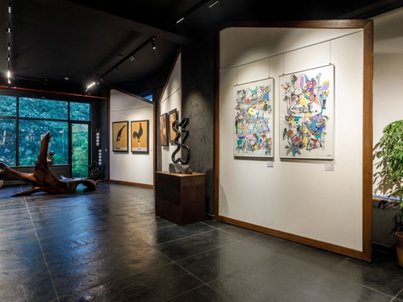 The gallery with colossal French windows looks out onto the verdure, inviting natural light. (Image Credits: Courtesy of IKKO)