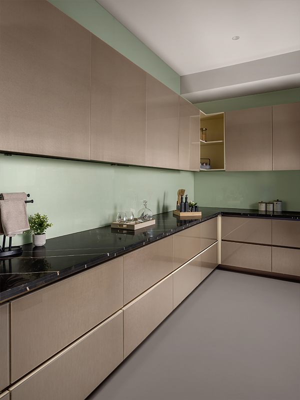 In the kitchen, gilded accents paired with stone infuse a touch of opulence to the space. (Image Credits: Courtesy of Parallel)