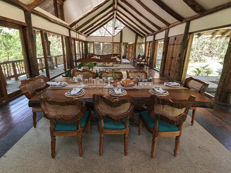 Additional features include tall ceilings, asymmetrical wooden and rattan furniture and a profusion of house plants to blur the inner-outdoors divide. (Image Credits: Earthitects)