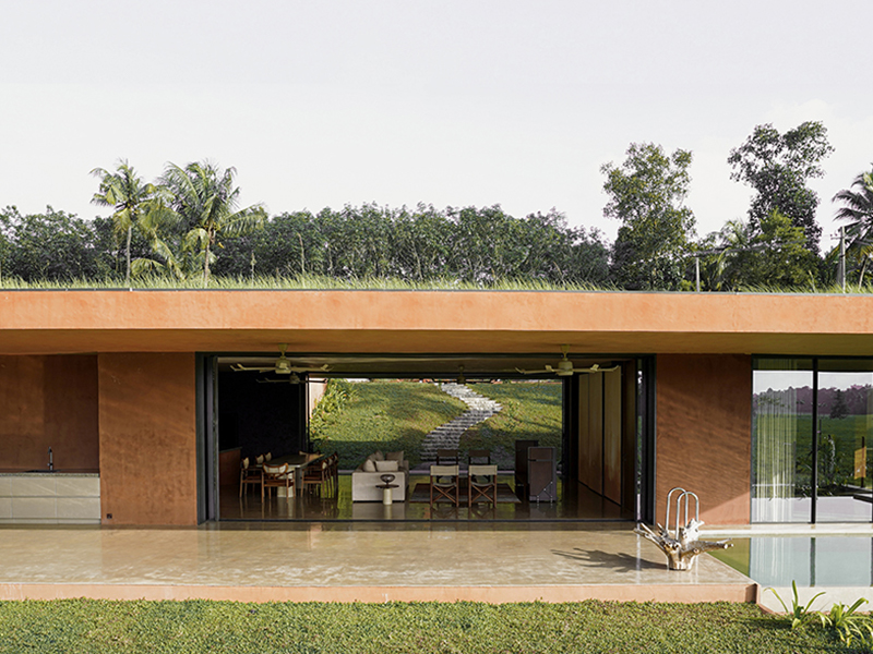 This Kochi home offers an immersive biophilic experience, where nature flows seamlessly through spaces. Custom fabrication and glazing by Excelteam Project Solutions enhance its fluid, light-filled design. (Image credit: Syam Sreesylam)