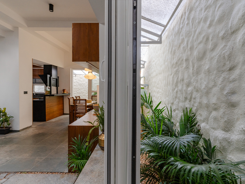 The colossal French windows allow the home to have a connection with the petite garden. (Image Credit: Priyanka Rajan)