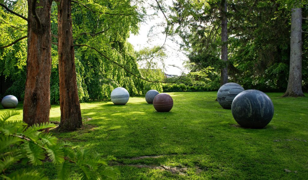 Artist Alicja Kwade created the eight large, perfectly rounded stone globes for the Moon exhibition in 2018, and the installation has remained on display ever since, a part of the sculptural park. (Image Credit: Kim Hansen)