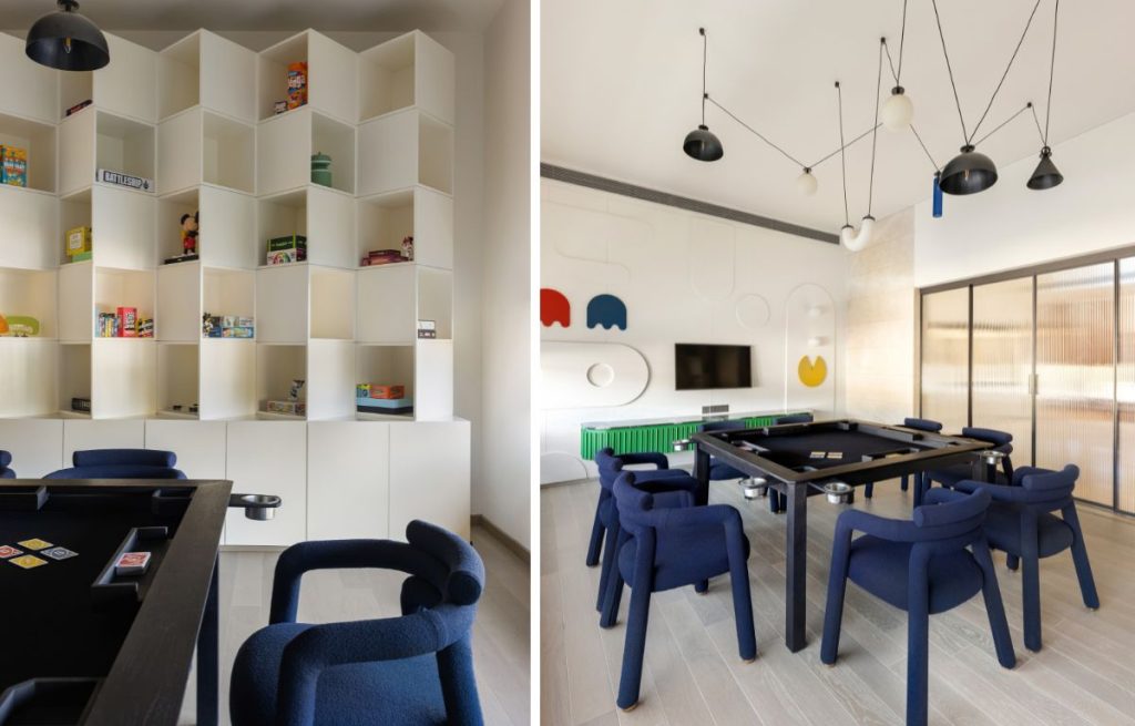 In the games room, a bespoke table from Maanavi Homes sits beneath a custom chandelier by White Lighting Solutions, while Pac-Man-inspired wall panelling, Scandinavian-style upholstered custom chairs and geometric shelving (custom-made on site) lend a whimsical nostalgia. (Image Credits: Purnesh Dev Nikhanj)