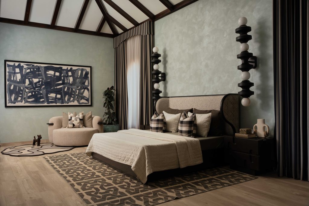 A calming yet curated space, the master bedroom features statement orb lamps from Kasto Design, luxurious beige fabrics by Season Furnishings, and a side table and bed from Sand Living that tie it all together. (Image Credits: The Matter Studio)
