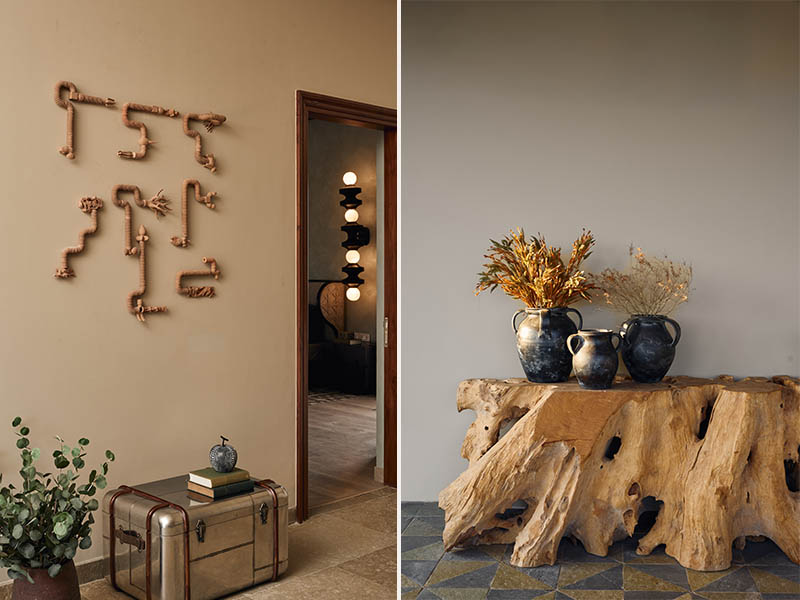 Left: The entrance to the master bedroom is elevated with a striking terracotta mural from Art Centrix Space, complemented by a chromatic sculptural table piece by Vahe Ensemble and sleek tabletop contemporary accents from Modern Quests. Right: The courtyard embraces an earthy aesthetic with rustic vases and a textured console table, both sourced from Pottery Barn, grounding the space in warmth and natural charm. (Image Credits: Rohit Mendiratta)