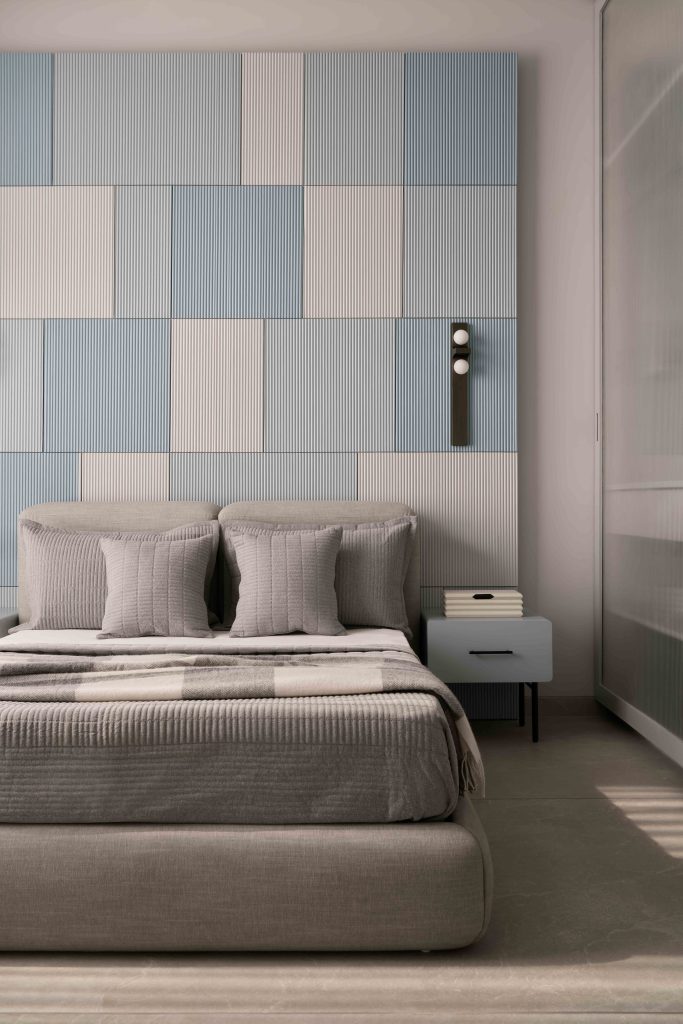 In the master bedroom, the tactile fluted wall panelling in shades of blue is finished with ICA paints. The bed and side table are designed by NH48, and the upholstered bedding material is from Housewarming. Locally picked wall sconces lend an ambient glow after sundown.
(Image Credits: Yadnyesh Joshi)