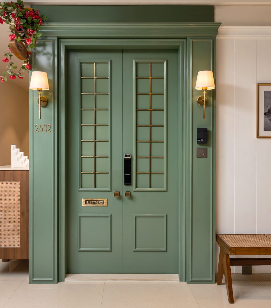 Nearby, rattan-fronted furniture lends utility, while archival black-and-white photographs of the city, grooved into the entryway wall, anchor Bombay’s colonial past as part of the visual architecture. Inside, a vintage chest, hand-carved mirror, and chesterfield pouffe compose a foyer vignette that feels both curated and lived-in. Also Read: Eat, Stay, Explore: Discover Copenhagen Through The Lens Of Design Design That Lets In The Sky