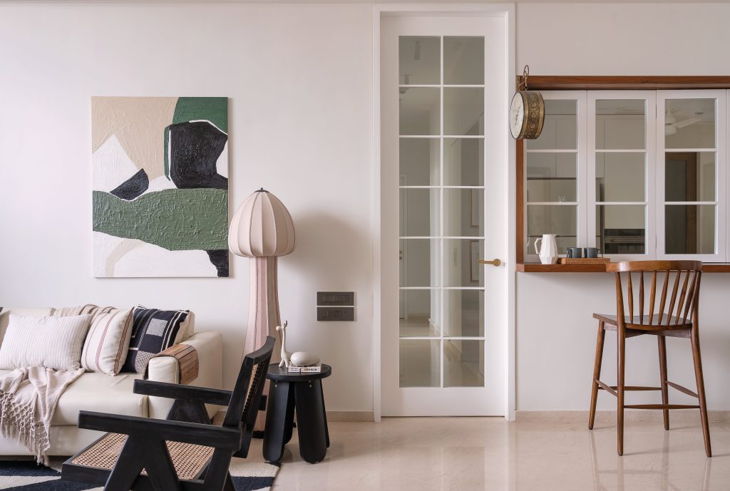 The living space strikes a chord between quietude and flair; speckled with whimsical pieces like a mushroom lamp from Name Place Animal Thing, a sculptural end table from Ek Design and an abstract artwork from Beeving Company. (Image Credits: Biju Gopal)