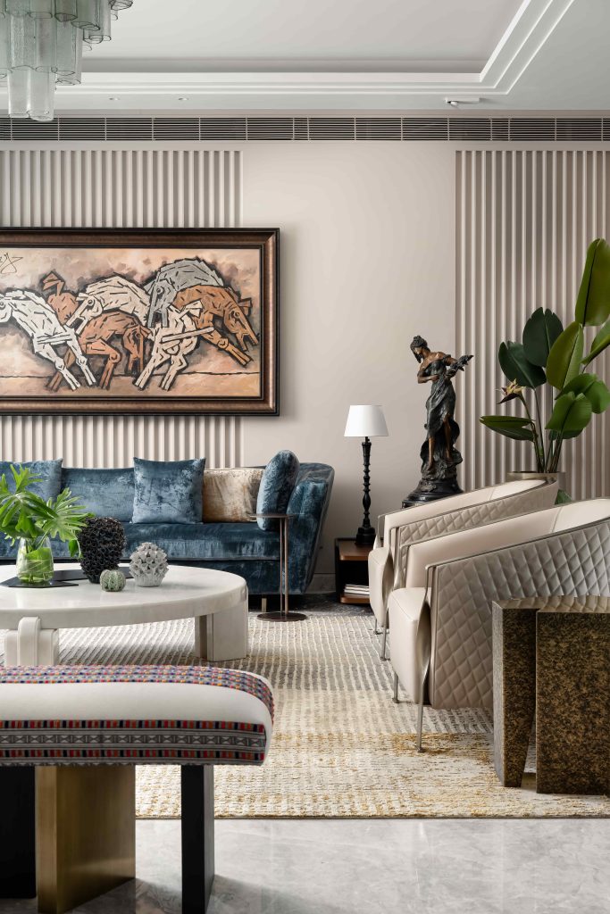 The formal living room blends modern eclecticism with curated global finds, including sofas from Casa Walls, sculptural décor, a gin table sourced from Europe, a table lamp, planters and a vase from Thailand, alongside a bench and brass table from K2, anchored by a marble centre table from the client’s collection. (Image Credits: Arjun Kirshna)