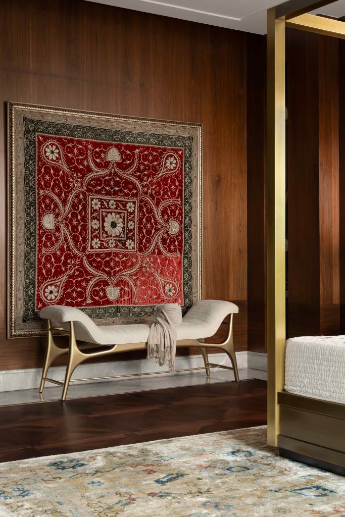 In the master bedroom, a pre-partition zardosi chadar from Lahore infuses the space with heritage, while a K2 bench in muted off-white and brushed gold lends a serene, contemporary balance. (Image Credits: Arjun Kirshna)