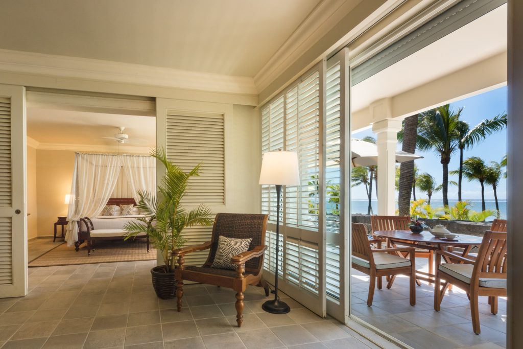 The One-Bedroom Colonial Oceanfront Suite features a king-size four-poster bed, a marble-clad bathroom and a generous oceanfront balcony — perfect for reclining on a sunbed while drinking in the spellbinding views of the Indian Ocean. (Image Credit: Residence Mauritius) 
