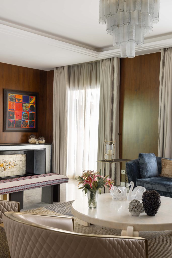 Anchored by an S.H. Raza painting, the room layers a console sourced from the Milan festival, paired with a K2 bench and a bronze side table, all shimmering under the subtle glow of a Thai candle. (Image Credits: Ravi Varma) 