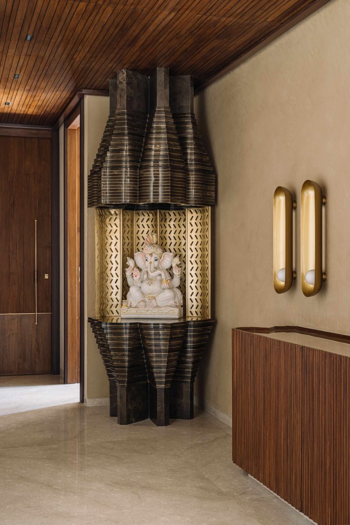 Ganesha rests within a lotus inspired-form, glimmering in brass, marble and inlay details. The console is from Poshway. (Image Credits: Ishita Sitwala) 