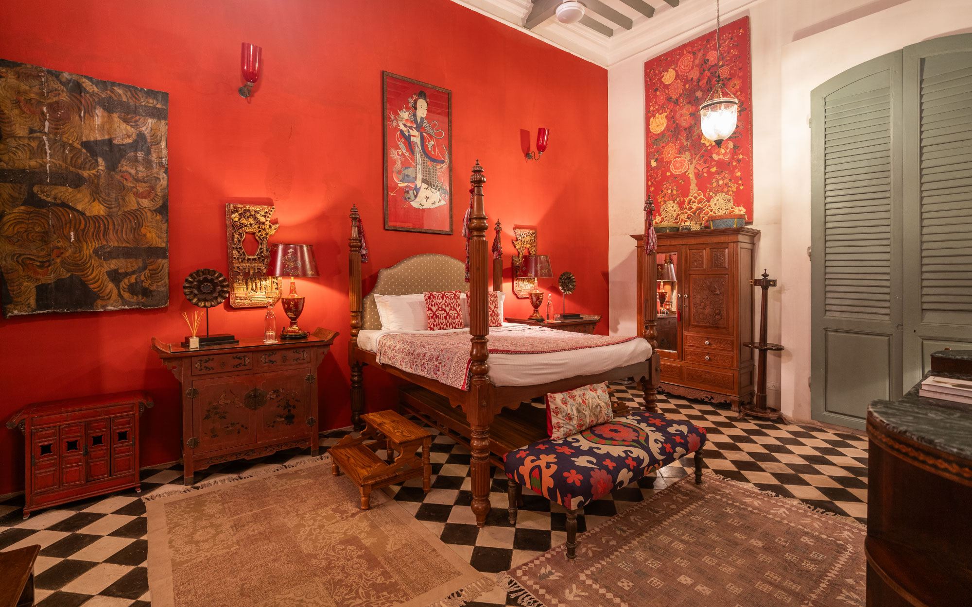 With Chinese embroidery and chests, and various other items acquired across the Indochinese peninsula, this cinnabar-red suite evokes a royal parlour. (Image Credit: Maison 26)