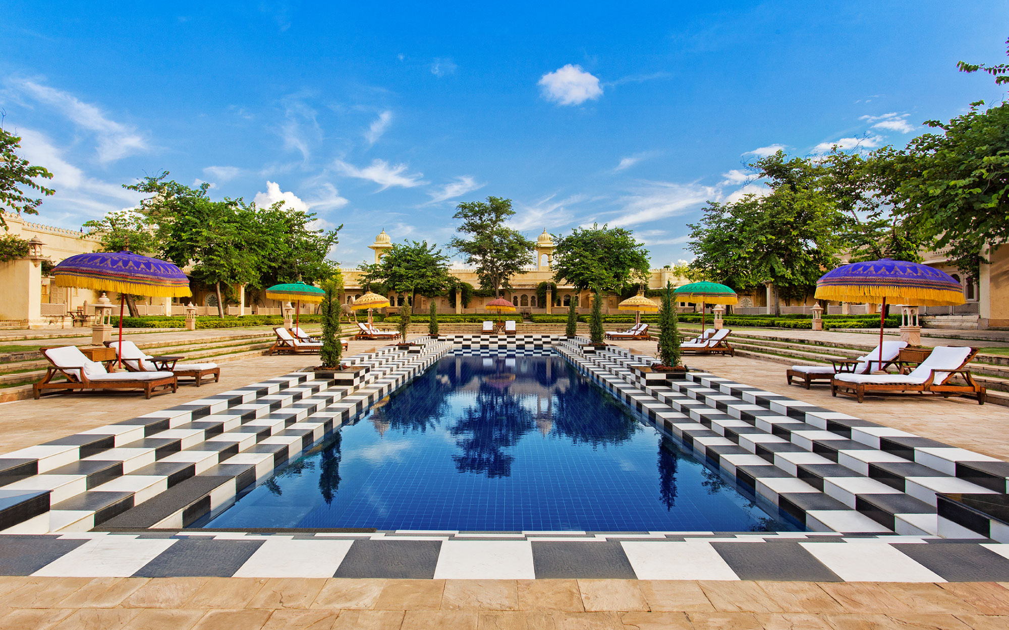 The pool with its chequered tiles is surrounded by arched corridors and towering chhatris. (Image Credits: Courtesy of The Oberoi Udaivilas, Udaipur)