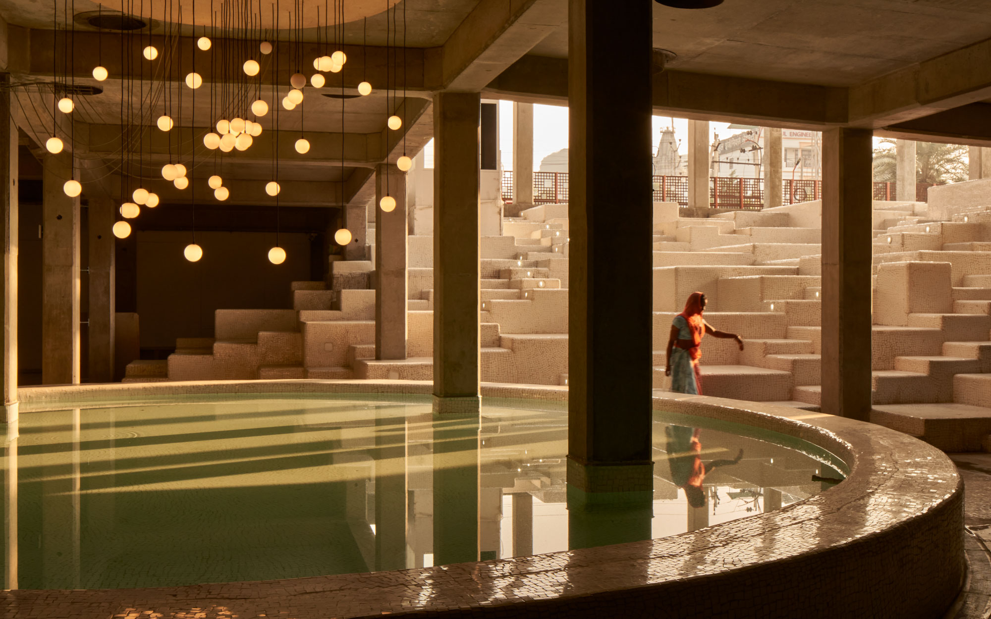 A central stage with stepped seating invites performances, fostering fluid, community-driven interaction. (Image Credits: Edmund Sumner)