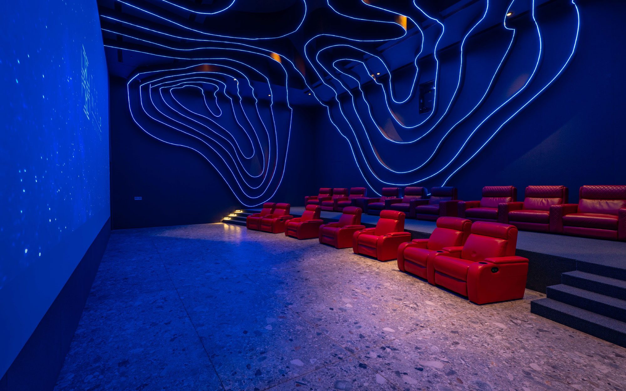 The theatre unfolds as a multisensory escape, where cinematic projections and ambient lighting bring The World’s story to life. (Image Credits: The World Experience Centre)