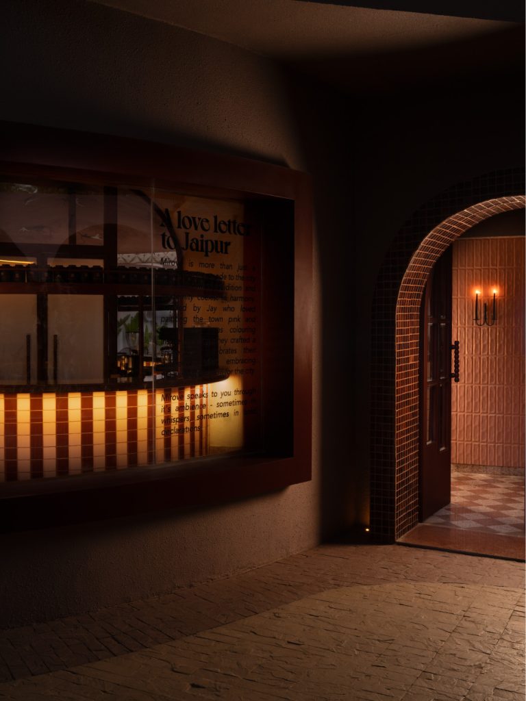 The space features a framed narrative window titled ‘A Love Letter to Jaipur,’ offering a glimpse into the bar beyond while grounding the entry in story and intent. (Image Credits: Avesh Gaur)