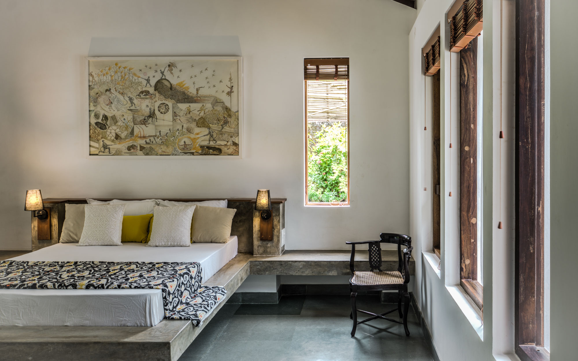 Navovado is an example of a contemporary vacation house that fits into the Goan village landscape, the teak wood furniture, built-in bed and green Kota flooring take centre stage among the white walls in this bedroom. (Image Credits: Sanjeet Wahi)