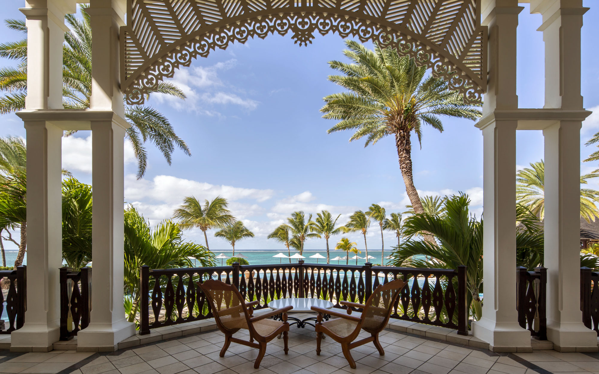 The lobby patio frames one of the resort’s most captivating ocean views, best savoured from rattan‑woven, colonial‑style plantation chairs. Image Credit: Residence Mauritius)
