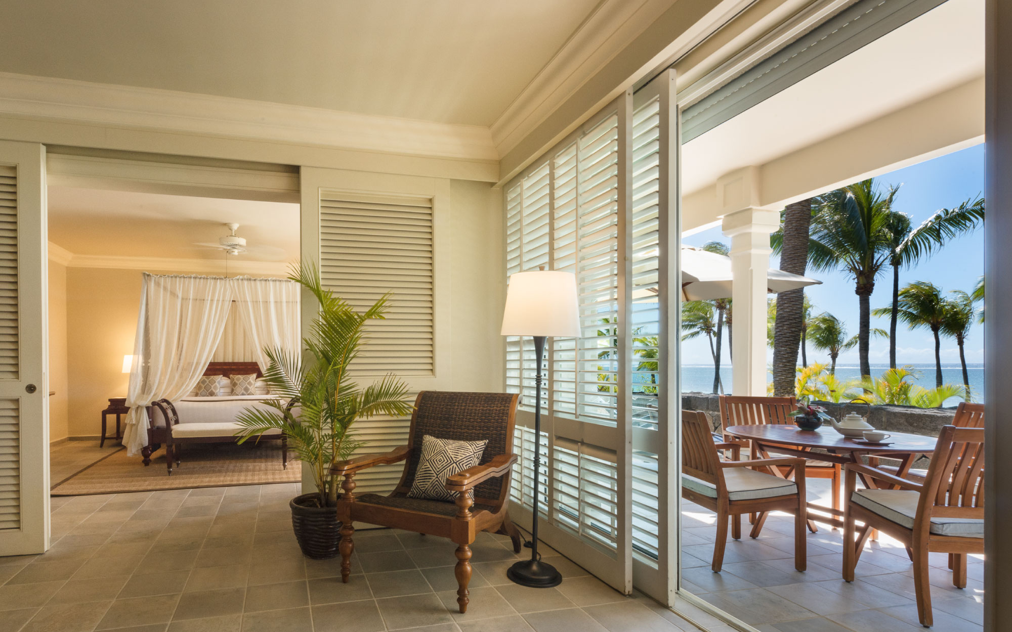 The One-Bedroom Colonial Oceanfront Suite features a king-size four-poster bed, a marble-clad bathroom and a generous oceanfront balcony — perfect for reclining on a sunbed while drinking in the spellbinding views of the Indian Ocean. (Image Credit: Residence Mauritius) 