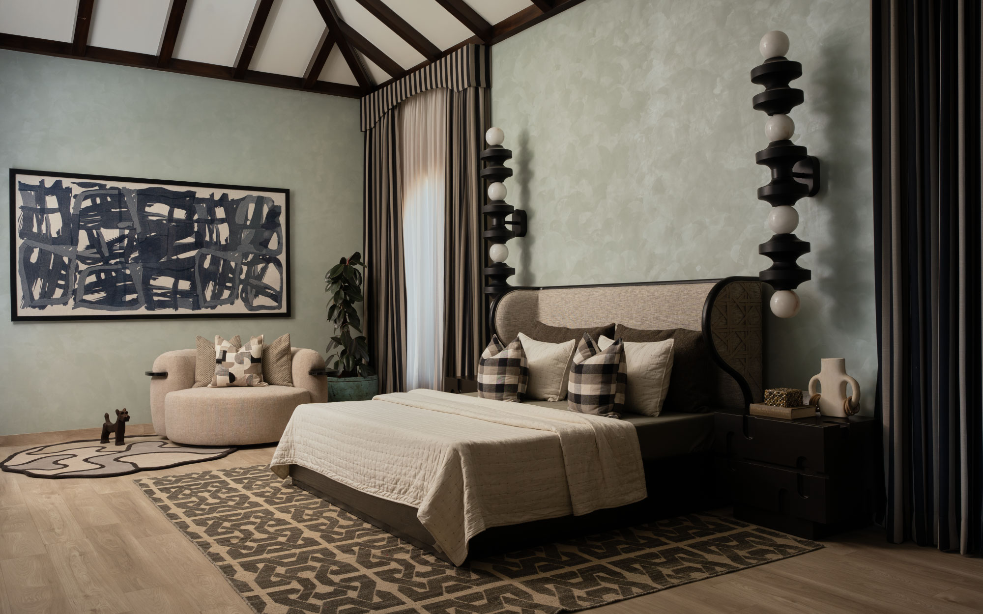 A calming yet curated space, the master bedroom features statement orb lamps from Kasto Design, luxurious beige fabrics by Season Furnishings, and a side table and bed from Sand Living that tie it all together. (Image Credits: Rohit Mendiratta)