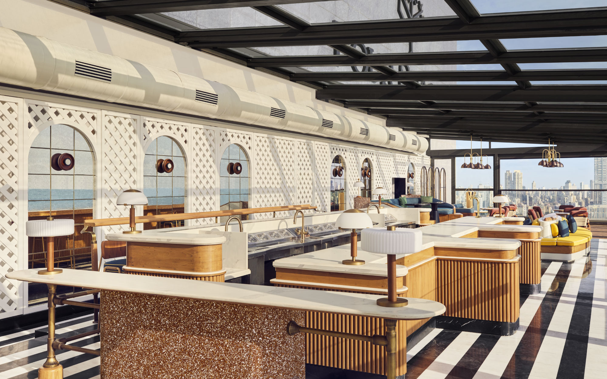 Designed by Atelier Pond, the rooftop pairs a retractable Wimbledon-style roof with nautically inspired interiors, unfolding into two distinct zones that mirror the city’s shifting rhythms. (Image Credit: Four Seasons Mumbai)