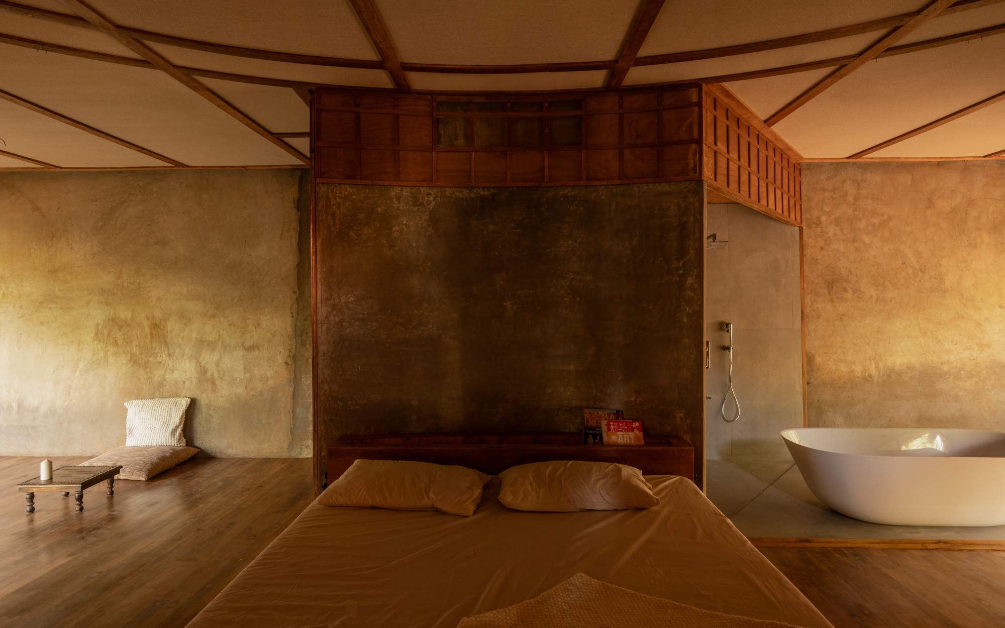 The bedroom unfolds as an open plan, with the bathroom and seating areas subtly angled to ensure privacy. (Image Credits: Studio IKSHA)