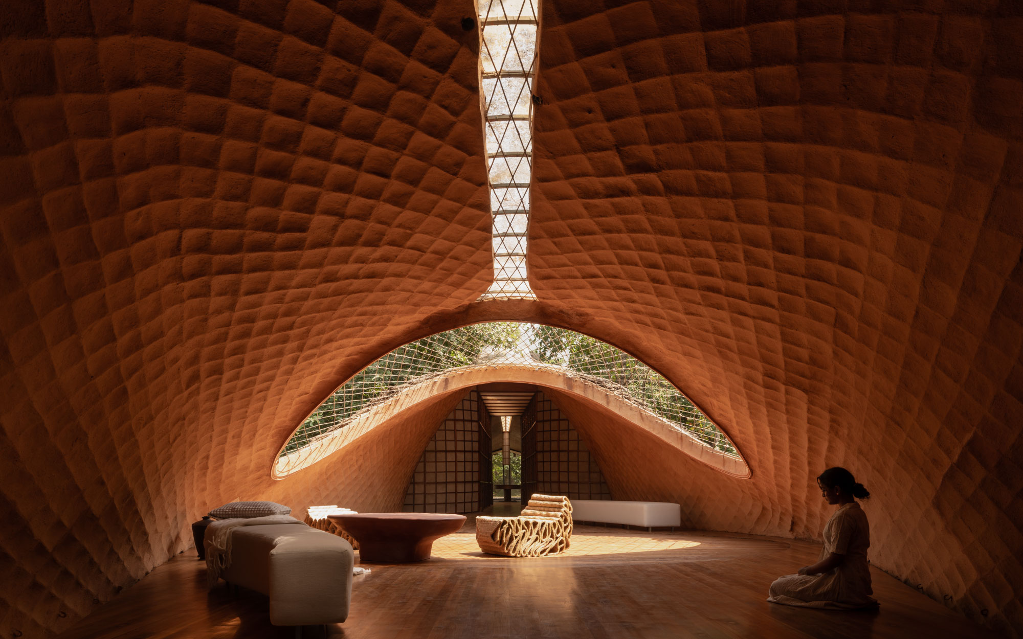 The home begins on the upper level, where the living and dining areas unfold first, allowing daily life to hover above the landscape before retreating into more private spaces below. (Image Credits: Studio IKSHA)