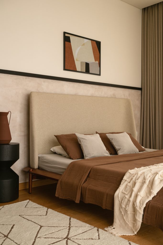 Earthy browns and creams coalesce with softened edges in the guest bedroom to compose a space that is tranquil without feeling spare. (Image Credits: Nayan Soni)