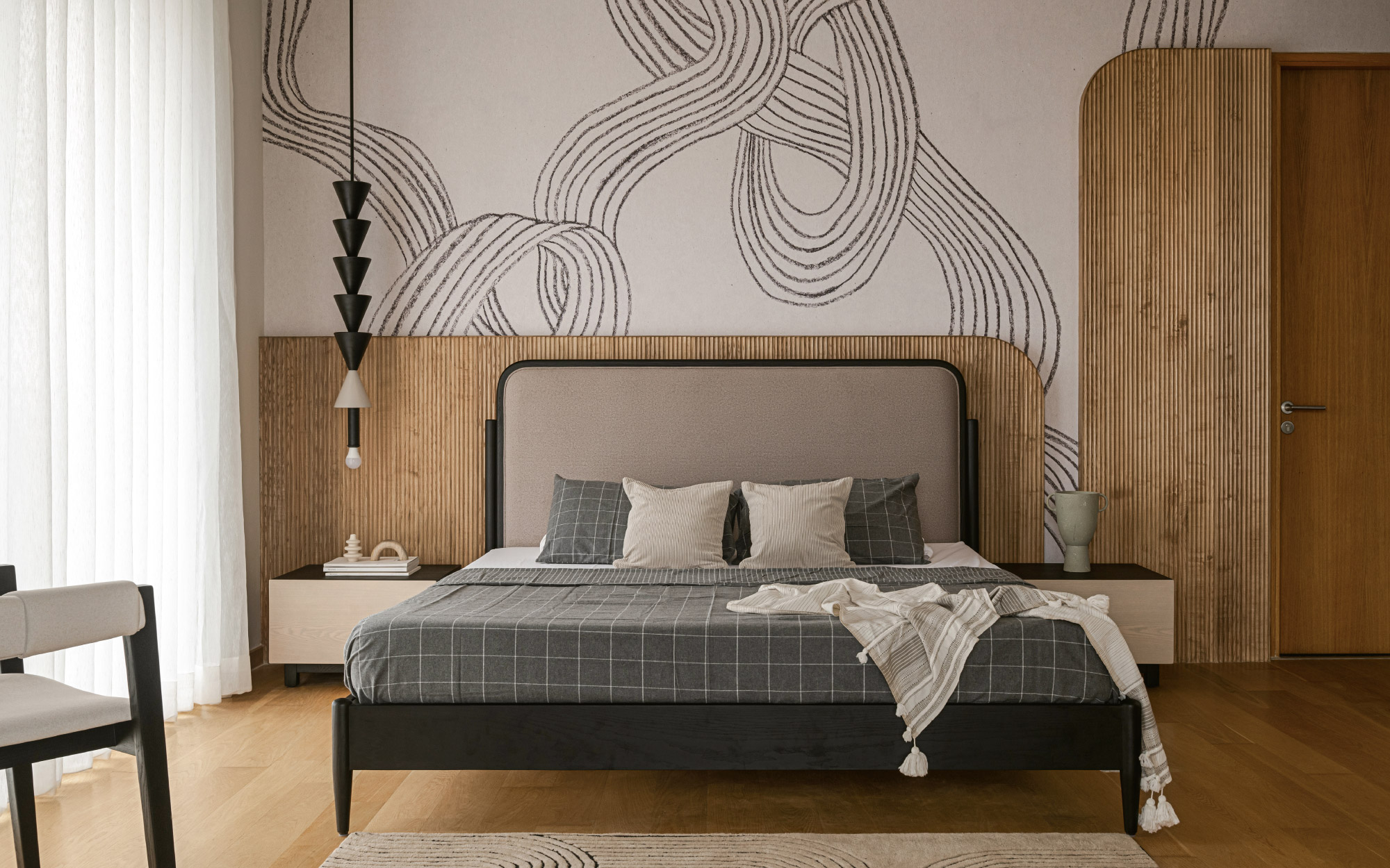 In the master suite, undulating patterns on the Moire wallpaper echo through the Obeetee carpet, binding the wall and floor in a seamless, textural continuity. (Image Credits: Nayan Soni)