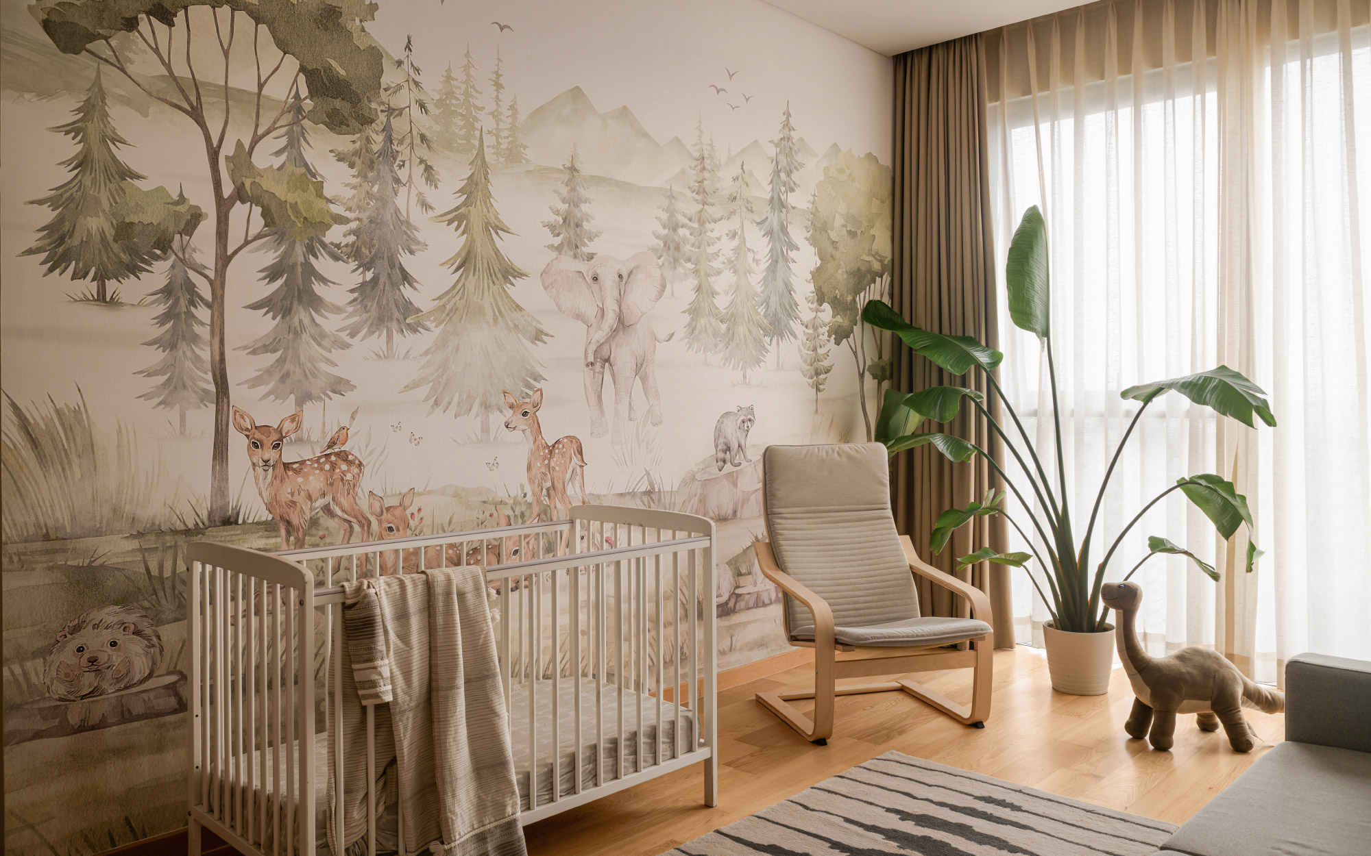A Life N Colors wallpaper sets a verdant backdrop in the nursery, where a Fisher Price crib and an IKEA rocking chair assemble a hushed landscape of care that is as tender in spirit as it is purposeful in design. (Image Credits: Nayan Soni)