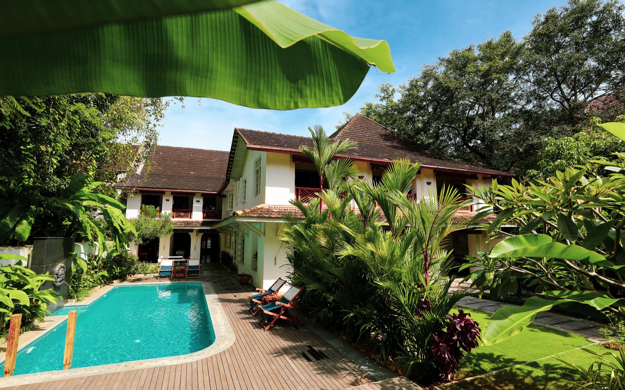 Verdant greens, timeworn architecture, and a still pool define the understated charm of Le Colonial 1506. (Image Credits: Le Colonial 1506)