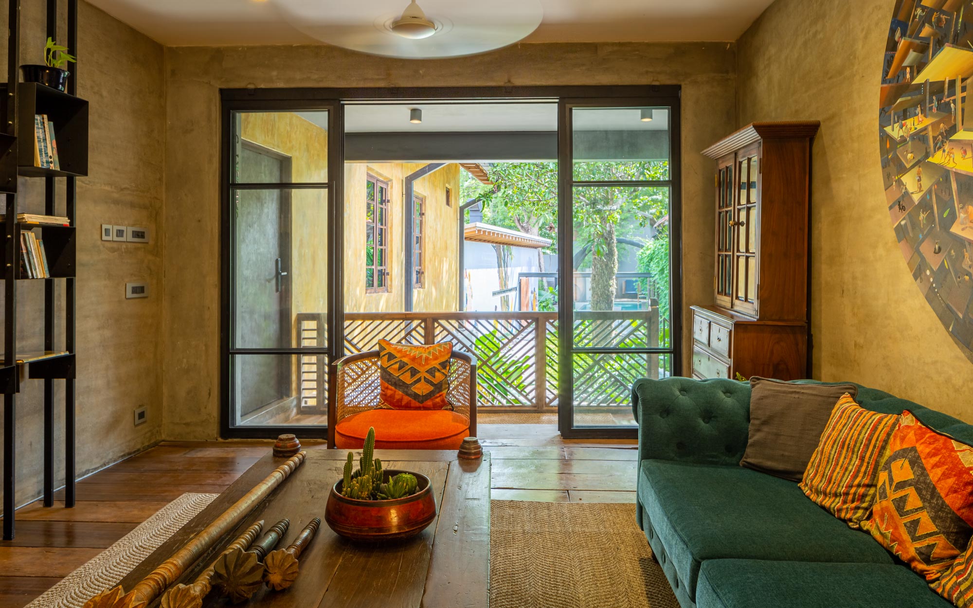 A quiet corner at The Postcard Mandalay Hall, framed by art, warm textures, and a seamless dialogue with the outdoors. (Image Credits: The Postcard Hotel)