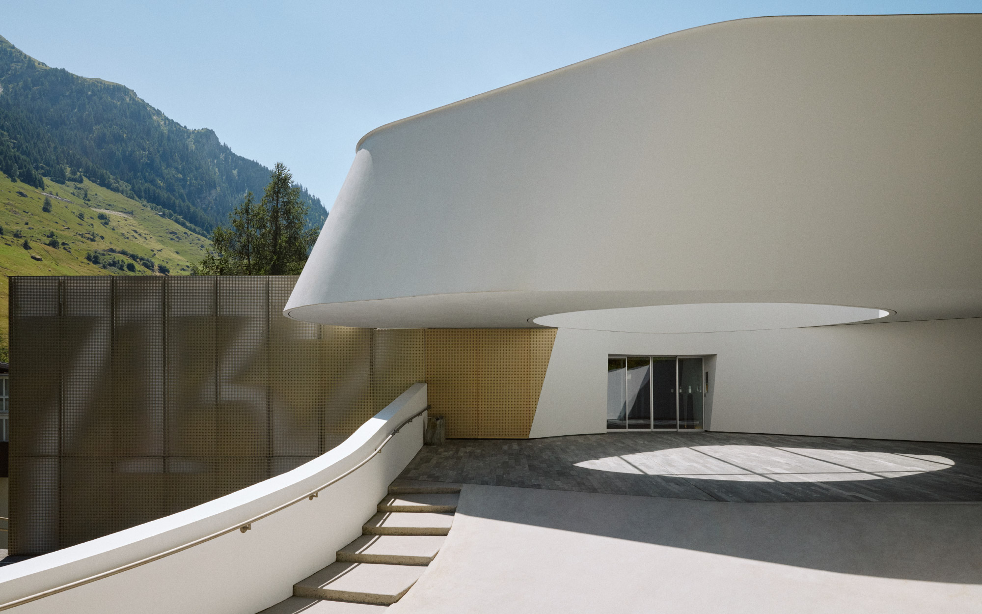 The monolithic building of raw concrete and 60,000 slabs of Vals quartzite pays homage to the archaic beauty of the Vals Valley. (Image Credit: 7132 Hotel)