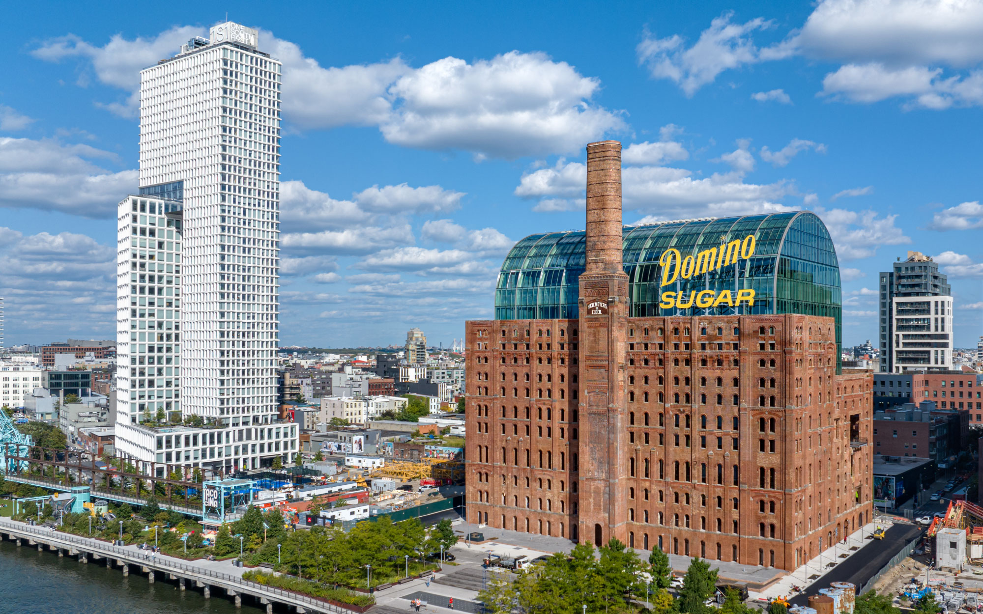 The historic Domino Sugar Refinery on Brooklyn’s waterfront, PAU’s first major built project, embraces nature through luminous spaces and vertical gardens while enjoying the fruits of the city. (Image Credits: Max Touhey)