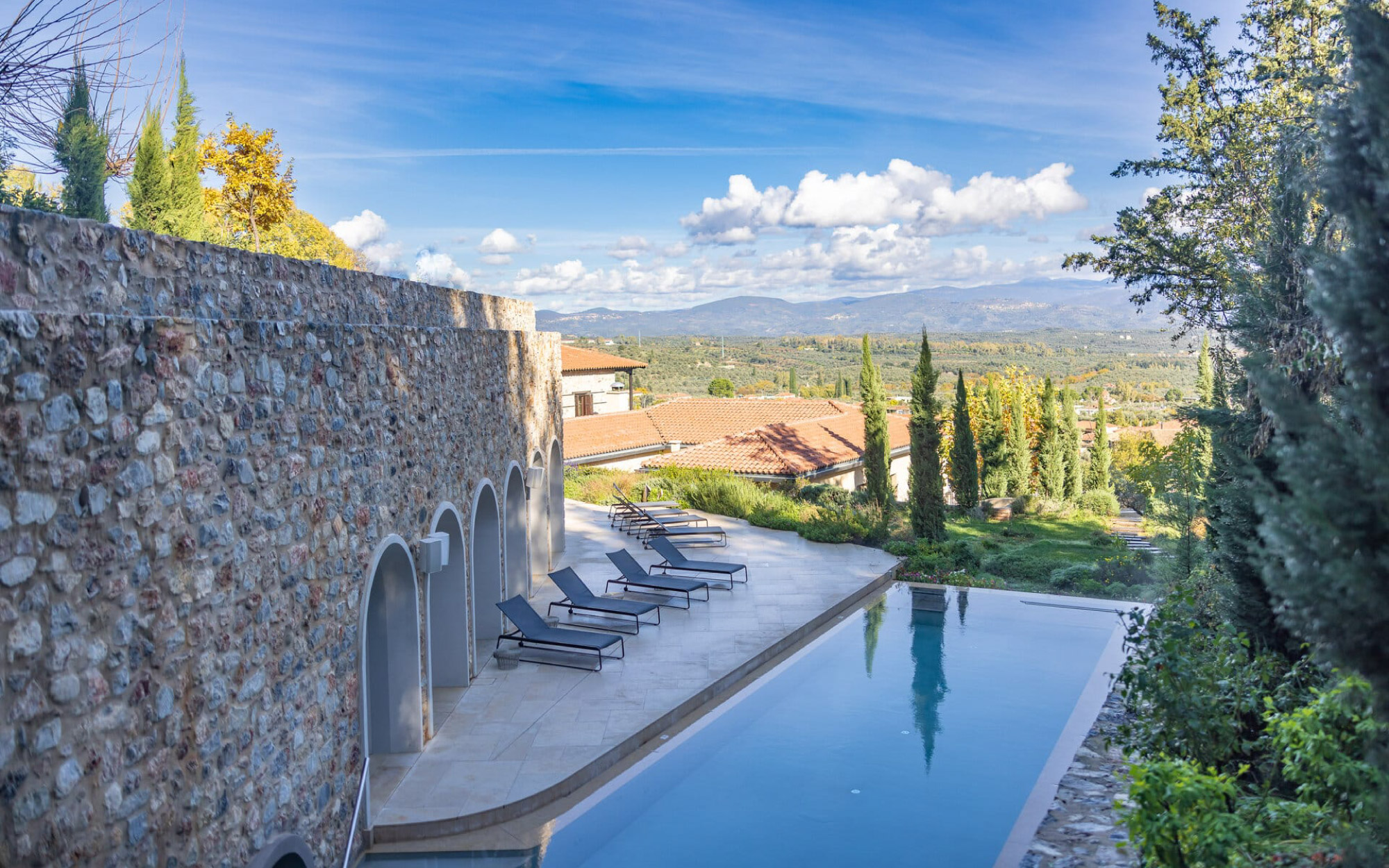 The tranquil waters of the outdoor pool with the scent of pine, and the gentle mountain air of Mystras carry one into a world of calm. (Image Credit: Euphoria Retreat Greece)
