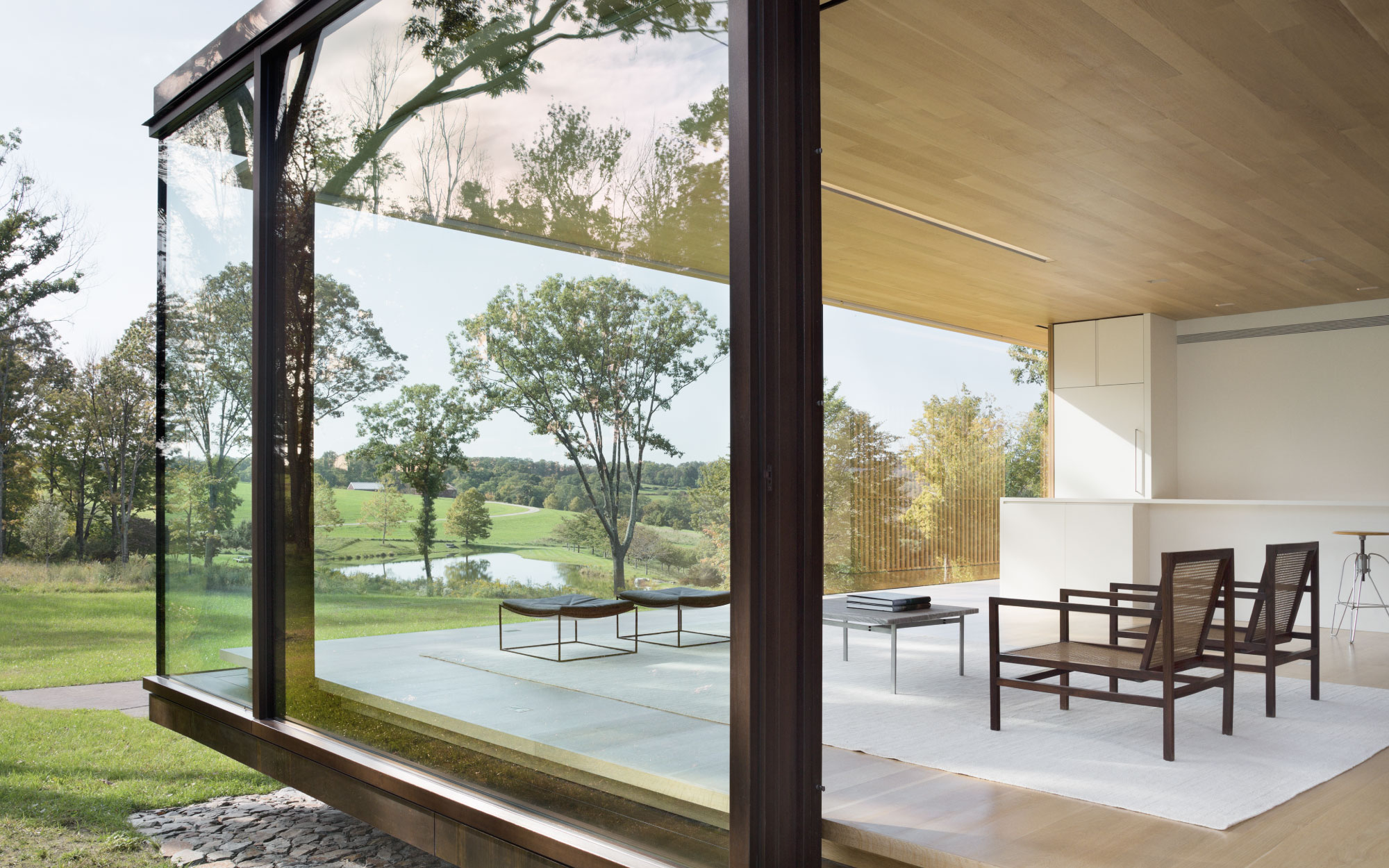 The LM Guest House is an incubator of phenomenal architectural concepts, featuring a continuous glass facade, custom wood details, and site-responsive sustainable strategies. (Image Credits: Paul Warchol)