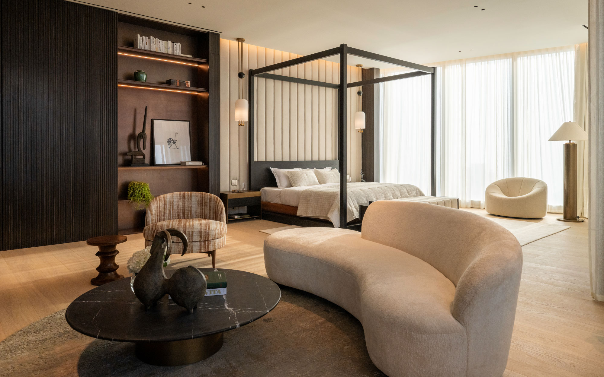 A Pumpkin armchair by Pierre Paulin for Ligne Roset and a Belle side chair by Demuro Das make for minimalist additions to the primary bedroom. (Image Credit: Patricia Goijens)