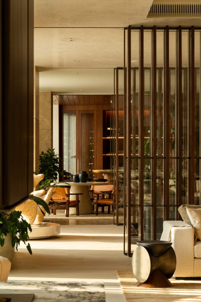 Wooden claustras or slatted partitions subtly divide spaces across the home without the worry of visual heaviness. (Image Credit: Patricia Goijens)