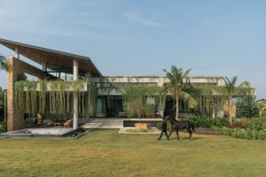 #DP Exclusive: A Weekend Home Bisected By Khammam Stone Walls And Poised Over A Koi Pond