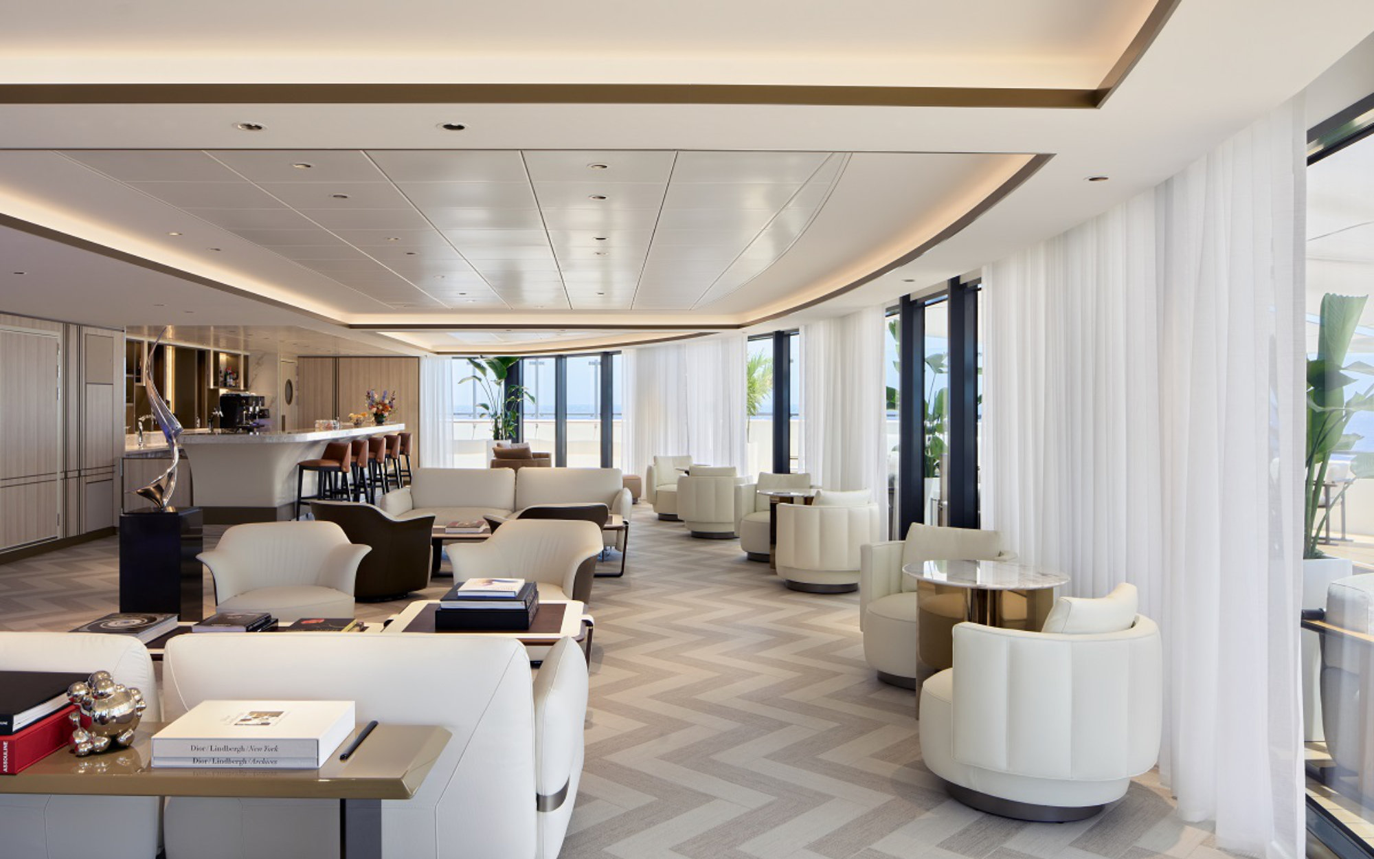 The Art Bar is a serene indoor–outdoor haven with panoramic views, art installations, and comfortable seating designed for relaxed gatherings. ( Image Credit: Ritz Carlton Yachts)