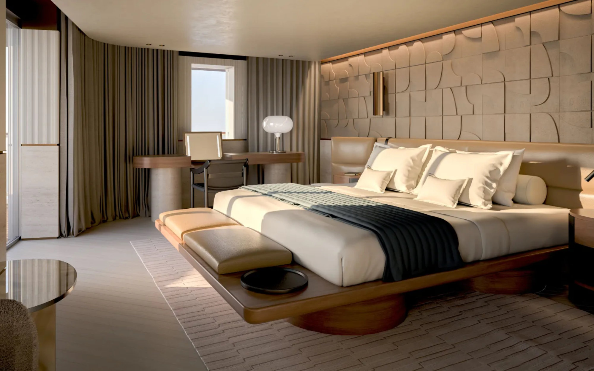 The bedroom offers panoramic sea views and features a travertine-crafted bathroom with a bathtub, separate shower, and private steam room, along with a spacious walk-in wardrobe—creating a serene, retreat-like sanctuary at sea. (Image Credit: Explora Journeys)