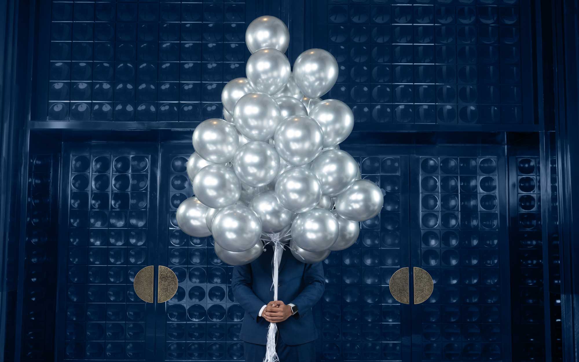Textured blue doors compress the space to create moments of intimacy, their deep tones absorbing LED light while recalling the colour’s historic association with rarity and prestige. (Image Credits: Four Seasons Mumbai) 