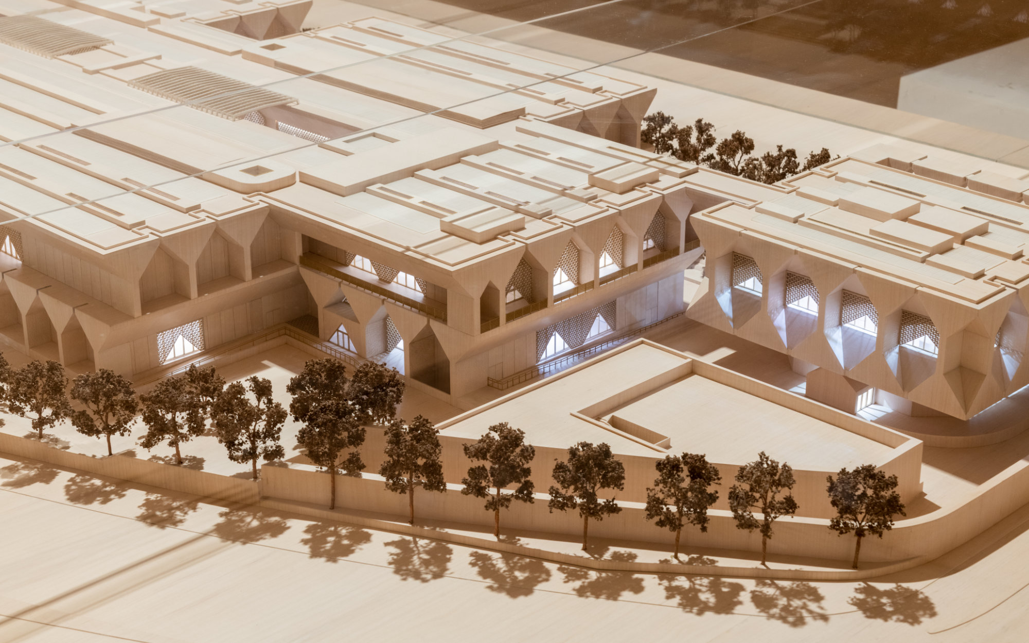 The facade features a textured pattern of repeating triangles, a symbolic geometry referencing its shared spiritual and structural importance in both Hindu and Muslim cultures. (Image Credits: Kiran Nadar Museum of Art) 
